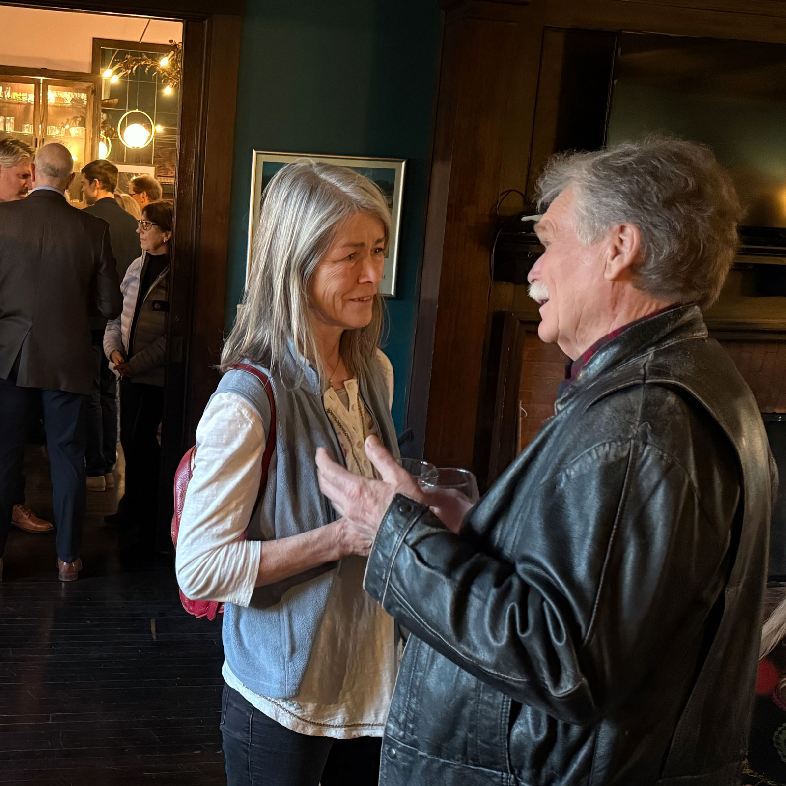 Board member Ken Schumacher talks with longtime friend and Stockbridge resident Mary Hart